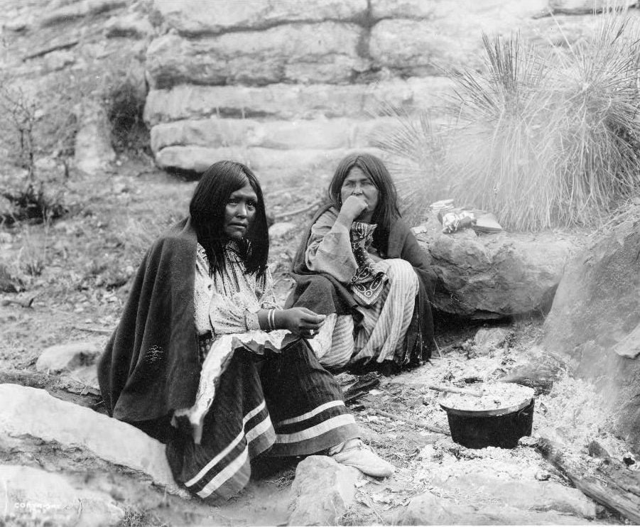 Two Apache Indian women at campfire